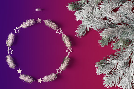 Christmas decorations arranged in a circle with copy space and Christmas tree frosty branches. Xmas background template for ads. New Year card designの写真素材