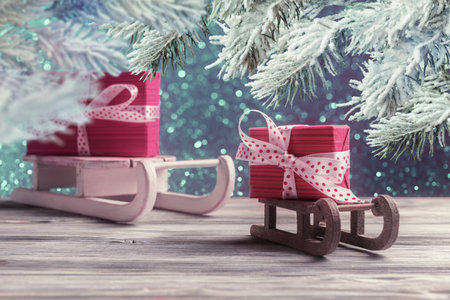 Red gift boxes on Santaâs sleighs. New Year and Christmas greeting cardの写真素材