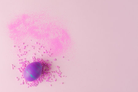 Easter holiday composition with painted egg in fluid art technique and pink stones. Concept of...