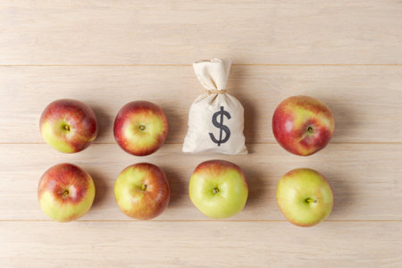 A symbolic depiction of a money bag surrounded by apples on a wooden surface, weaving themes of...