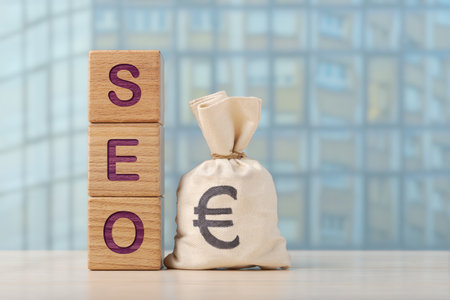 Wooden blocks spell SEO and money bag with Euro symbol. This image symbolizes the intersection of search engine optimization and budgeting for online successの写真素材