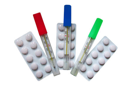 Tablets in plates for improving vision and thermometers on a white backgroundの写真素材