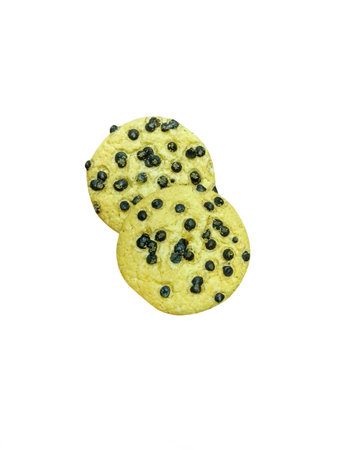 Yellow cookies covered with chocolate chips on a white backgroundの写真素材