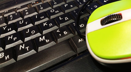 A close-up of a laptop keyboard and mouseの写真素材