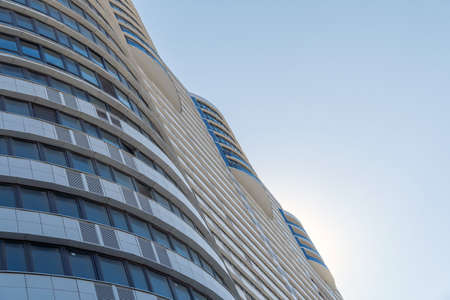 Modern multi-storey building with blue glass surfaces against the sky