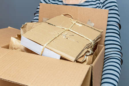 Girl holding cardboard box with paper, cartoon used waste, garbage for recycling