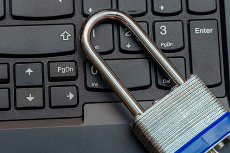 Metal lock on the black keyboard close up