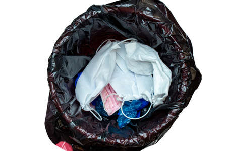 thrown out, discarded medical gloves and protective masks in the trash bin after quarantine