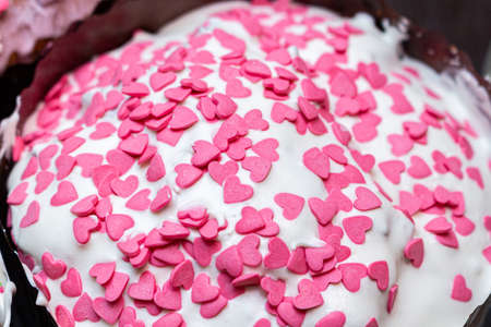 sugar glazed icing cake coating, decorated with colored candy sweets close up background