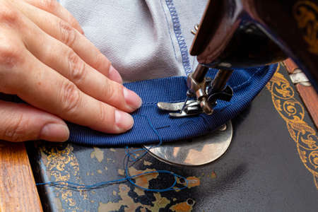 Stitching, sewing on an old, retro, vintage sewing machine close up