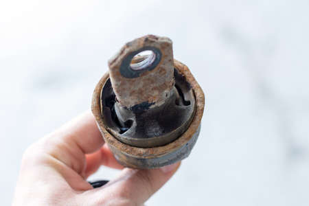 old cracked torn damaged silent block close up selective focusの写真素材