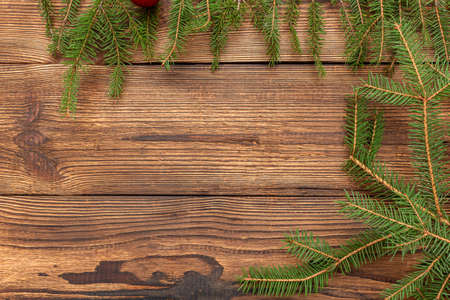 Fur spruce pine coniferous branches on the brown brushed wooden backgroundの写真素材