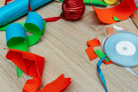 colorful wrapping paper with ribbons stripes on a wooden brown background. The concept of preparing for the holidays New Year and Christmas.の写真素材