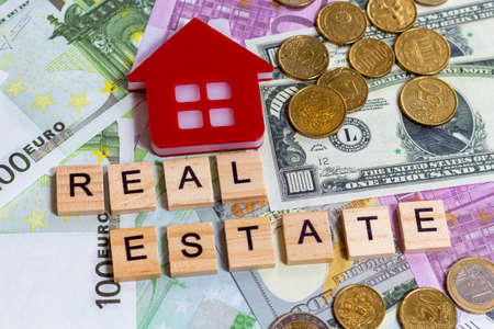 word text real estate or buy on the money banknotes backgroundの写真素材
