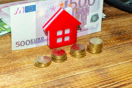 Home house on the staked coins background euro pile pack real estate concept expenses property buying mockup copy space close up background selective focusの写真素材