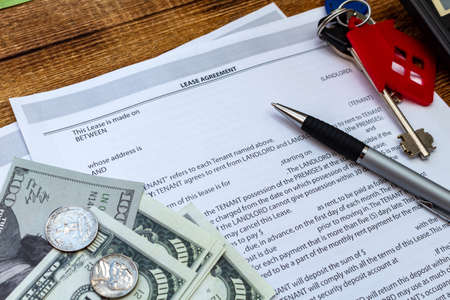 House, home, property, real estate lease rental contract agreement pen money coins keys wooden...