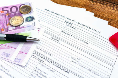 House, home, property, real estate purchase buying sale contract agreement pen money coins keys wooden background, expenses, buying, investment, finance, savings, concept close up selective focusの写真素材