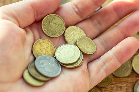 Hand holding full of coins palm payment donation concept economy finance