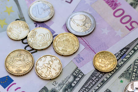 Pack of US dollars and euro banknotes and coins background finance economy currency close up...