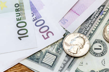 Pack of US dollars and euro banknotes and coins background finance economy currency close up...