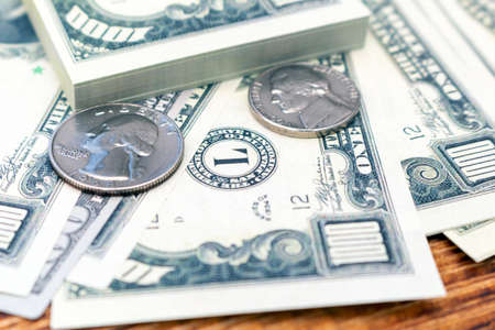 Pack of dollars banknotes and coins background finance economy currency close up selective focus US...
