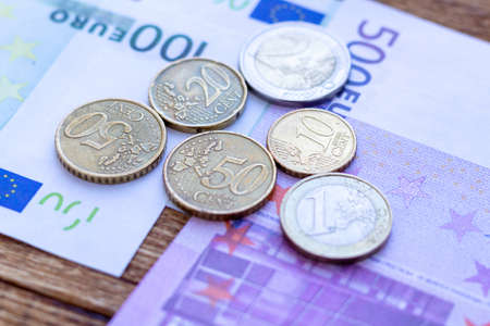 Pack of euro banknotes and coins background finance economy currency close up selective focus Europe...