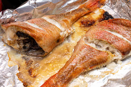 sea bass grouper homemade baked in a foil in the ovenの写真素材