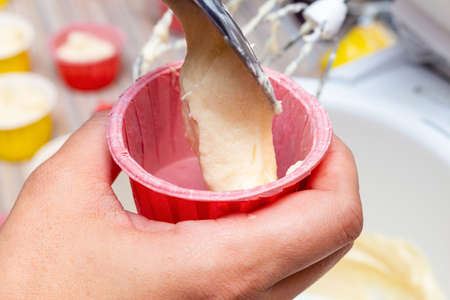 Cooking cupcake muffin raw dough in a form