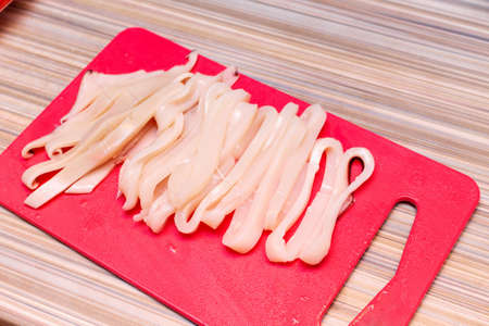 cooking raw squid rings at homeの写真素材