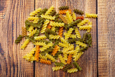 pasta colorata, Ñolorful spaghetti, fusilli, macaroni on wooden background close up selective...