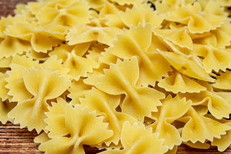 spaghetti, farfalle, macaroni, pasta traditional Italian on wooden background close up selective...
