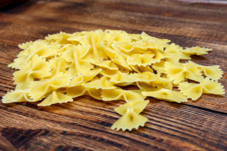 spaghetti, farfalle, macaroni, pasta traditional Italian on wooden background close up selective...