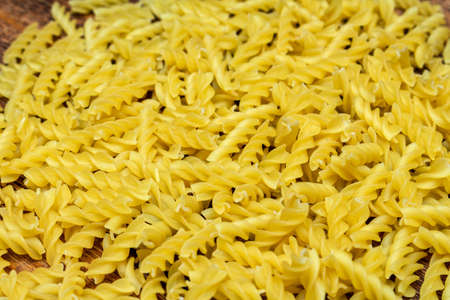 spaghetti, fusilli, macaroni, pasta traditional Italian on wooden background close up selective focusの写真素材