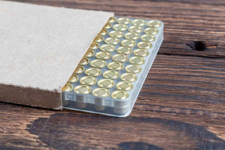 reloading process shotgun shells with special reload equipment. Powder, bullets, fraction, shells, buckshot on the wooden backgroundの写真素材