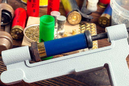 Shotgun shells reloading process with special reload equipment. Powder, bullets, fraction, shells,...