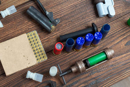 Shotgun shells reloading process with special reload equipment. Powder, bullets, fraction, shells,...