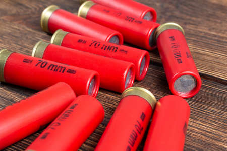 12 gauge caliber color cartridges hunting shells box pack on a brown wooden background