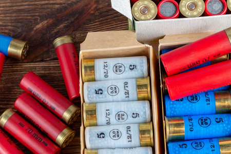 12 gauge caliber color cartridges hunting shells in a box pack on a brown wooden background