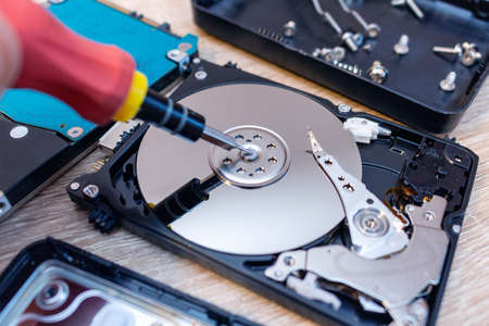old broken hard disk drives composition in a repair recovery service concept close up selective...