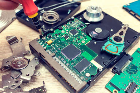 old broken hard disk drives composition in a repair recovery service concept close up selective...