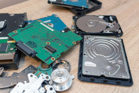old broken hard disk drives composition in a repair recovery service concept close up selective...