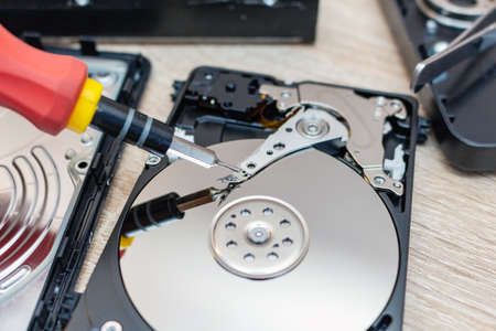 old broken hard disk drives composition in a repair recovery service concept close up selective...