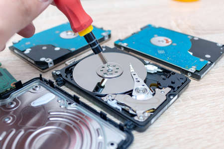 old broken hard disk drives composition in a repair recovery service concept close up selective...