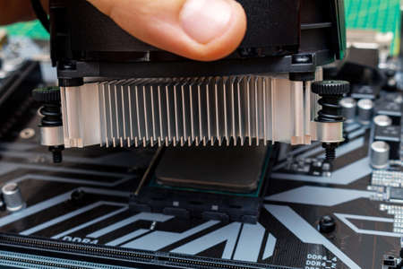 Installing a cooler on a personal computer processor. The process of upgrading computer maintenance in a service.の写真素材