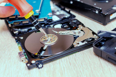 old broken hard disk drives composition in a repair recovery service concept close up selective...