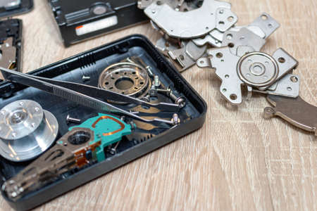 old broken hard disk drives composition in a repair recovery service concept close up selective...