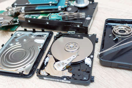 old broken hard disk drives composition in a repair recovery service concept close up selective...