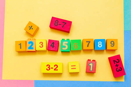 child kid colorful education toys cubes with numbers math pattern background on the bright...