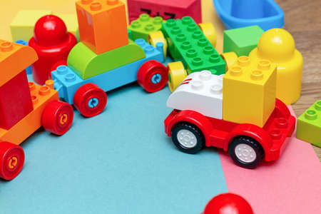 pack of colorful child kidâs education toys constructor train pattern background on the bright color background close up. Childhood education play infancy children baby conceptの写真素材