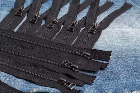 Pack a lot of black metal brass zippers stripes with sliders pattern for handmade sewing tailoring...